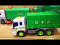 A miniature car with a large amount of blue and green garbage trucks.