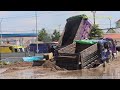 Dump truck 5 ton struck in deep mud & recovery by Komatsu Bulldozer