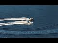 Drone shots of a guy riding the waves on his jet ski