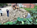 Great technique new project to filling up water Area with much stone  by Bulldozer ft dump trucks