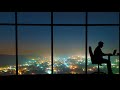 the man working near a window on a night city background time lapse
