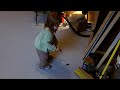 Amelia tapping areas of cottage floor containing blue tape