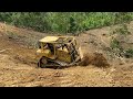 It's a crazy idea! CAT D6r XL bulldozer makes a terrace on a high cliff