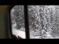 riding amtrak through snowy Cascade mountains