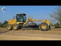 Awesome busy heavy motor grader machine working on a road construction project In the countryside