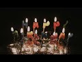 Happy Birthday Candles Burning In Dark with Reflective Silver Background Yellow Flames 4K