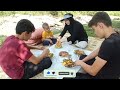 Cooking chicken with organic vegetables and fresh bread by the river in the middle of the forest