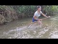 Two sisters set a fishing net in the stream and caught many big carps