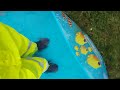 Splashing & paddling in a paddling pool in my hi-vis waterproofs & Blue Border Wellies.