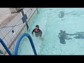 Little girl jump over the swimming pool: