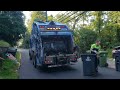 Two Republic Services Mack LR Mcneilus rear loaders on residential trash pickup.