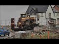 Bulldozer slips off truck