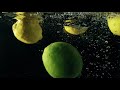 Lemons/limes falling in water *stock footage*