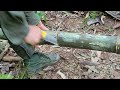 Build a survival shelter using bamboo in the forest, boiled flukes & a wood stove