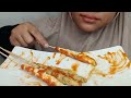 EATING EGG ROLLS WITH SPICY SAUCE