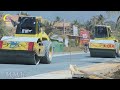 Each truck waits its turn to unload the gravel onto the road surface or into a gravel paver machine.