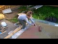 Amelia painting brown OSB with roller