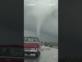 Cars drive by tornadoes tearing across Texas and Nebraska