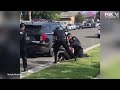 Police officers stop fellow officer punching handcuffed woman during arrest