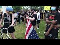 Protester climbs post to hang  Black Lives Matter flag